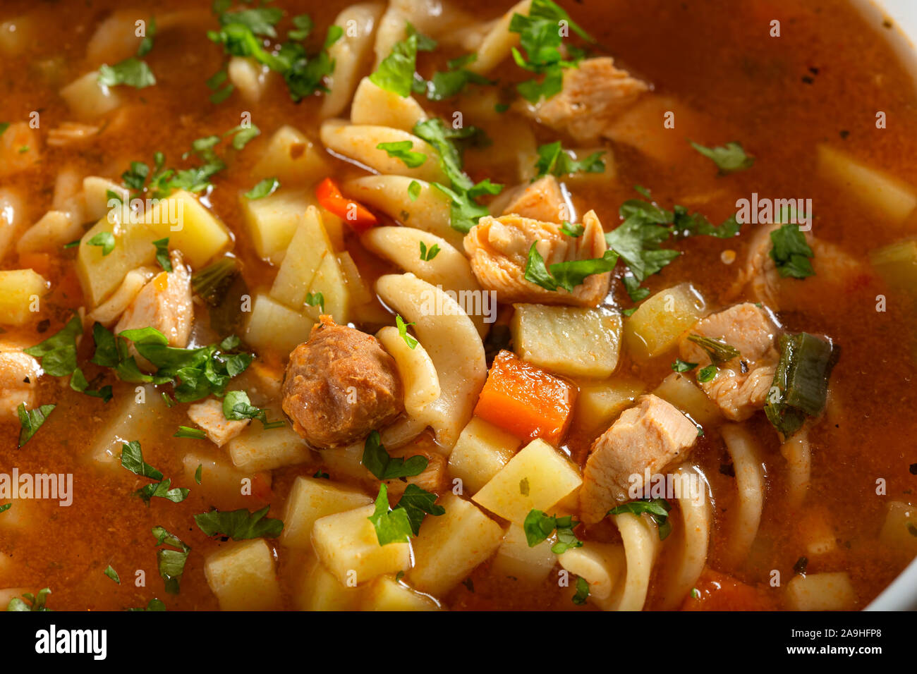 Soup with fusilli, chicken meat and vegetables - close up view Stock Photo