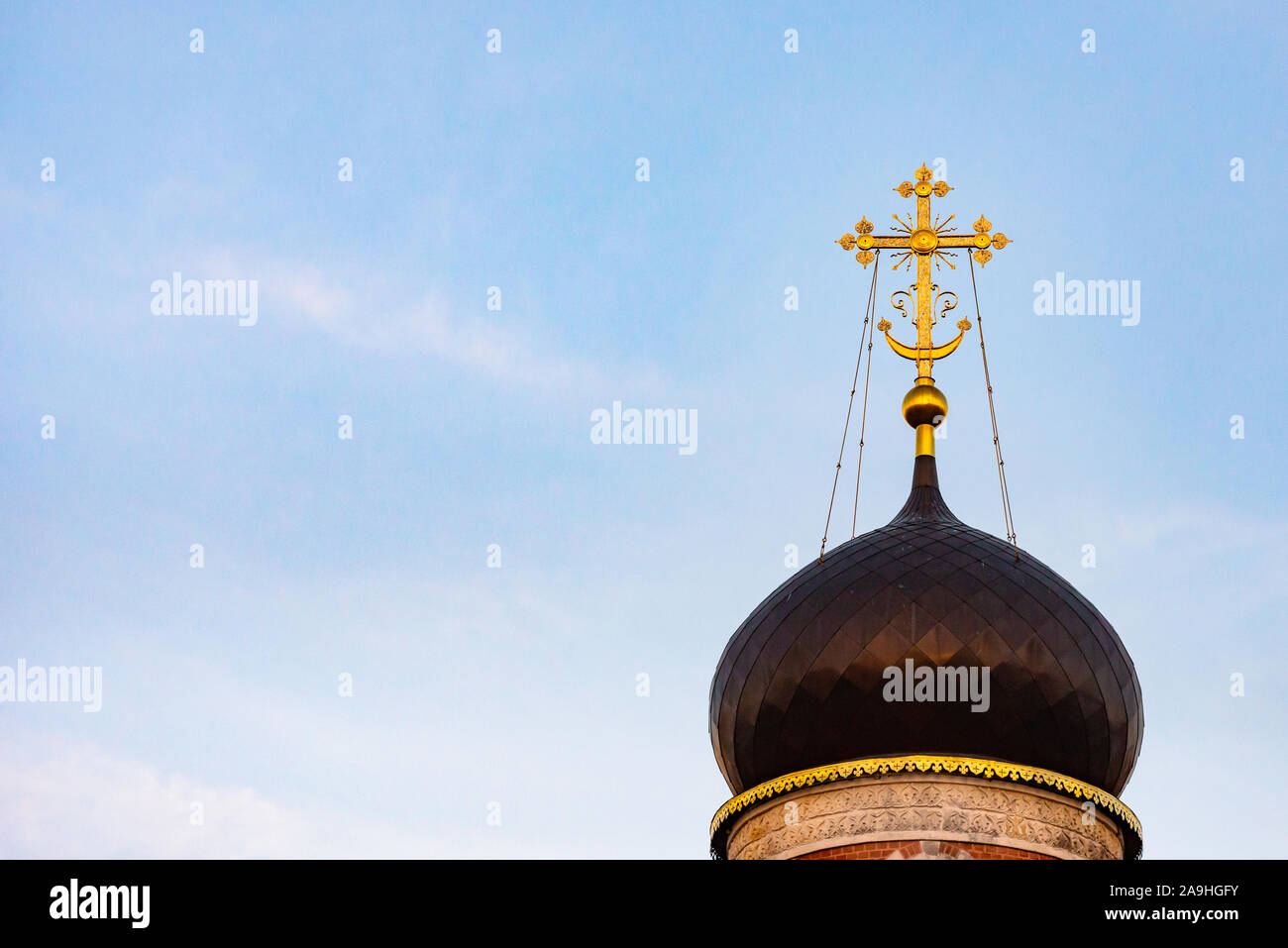 Golden cross on the dome. The dome of the Orthodox Church against the sky. Stock Photo
