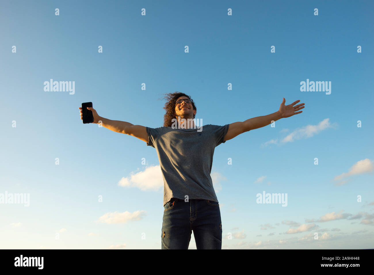 Man raising their arms in the air hi-res stock photography and images ...