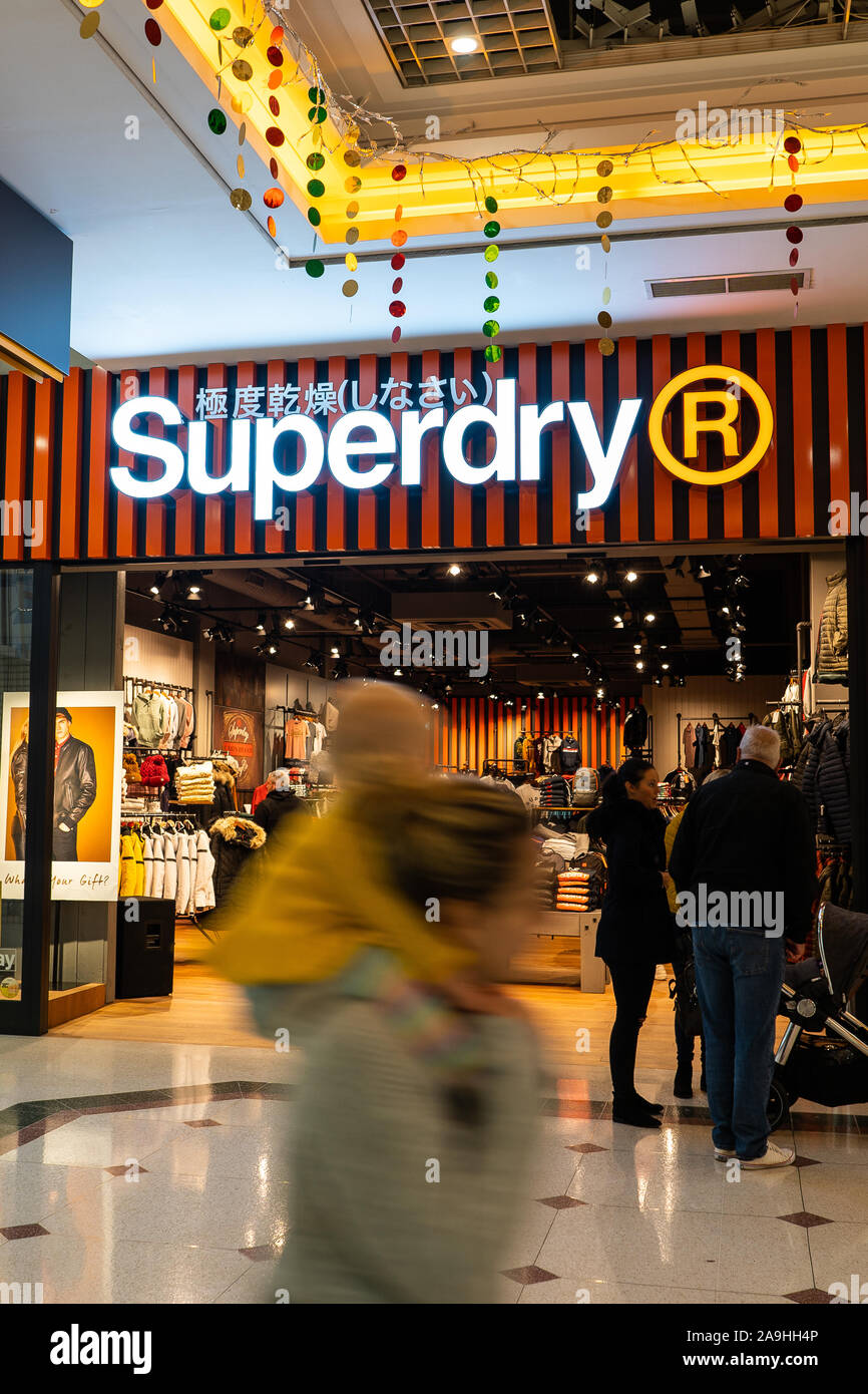 Shoppers passing the new Superdry store, shop located in the Intu Potteries  shopping centre in the heart of the city, Hanley, Stoke on Trent Stock  Photo - Alamy