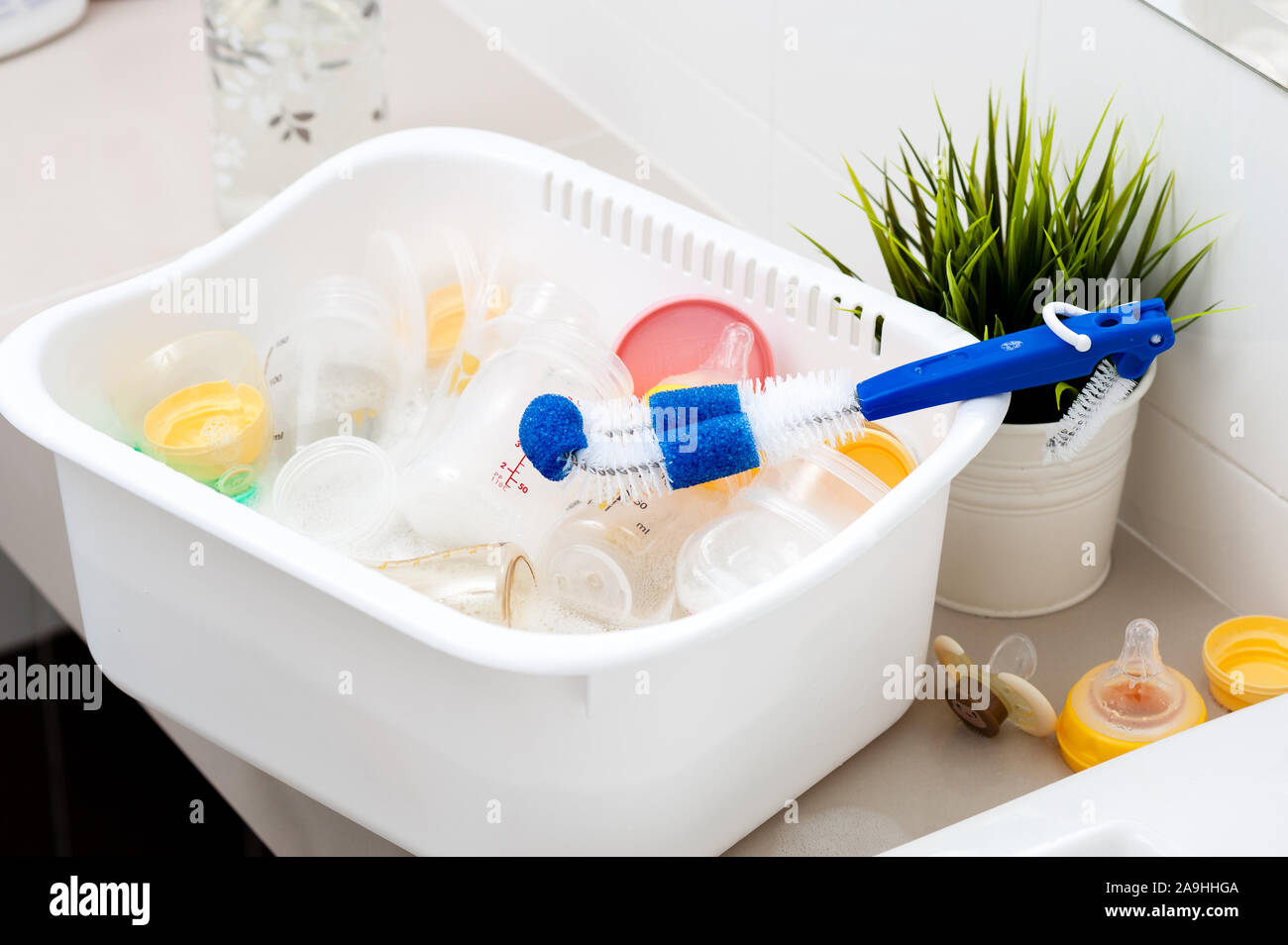 washing baby bottles and nipples with soft bottle brush and dishwashing  liquid Stock Photo - Alamy