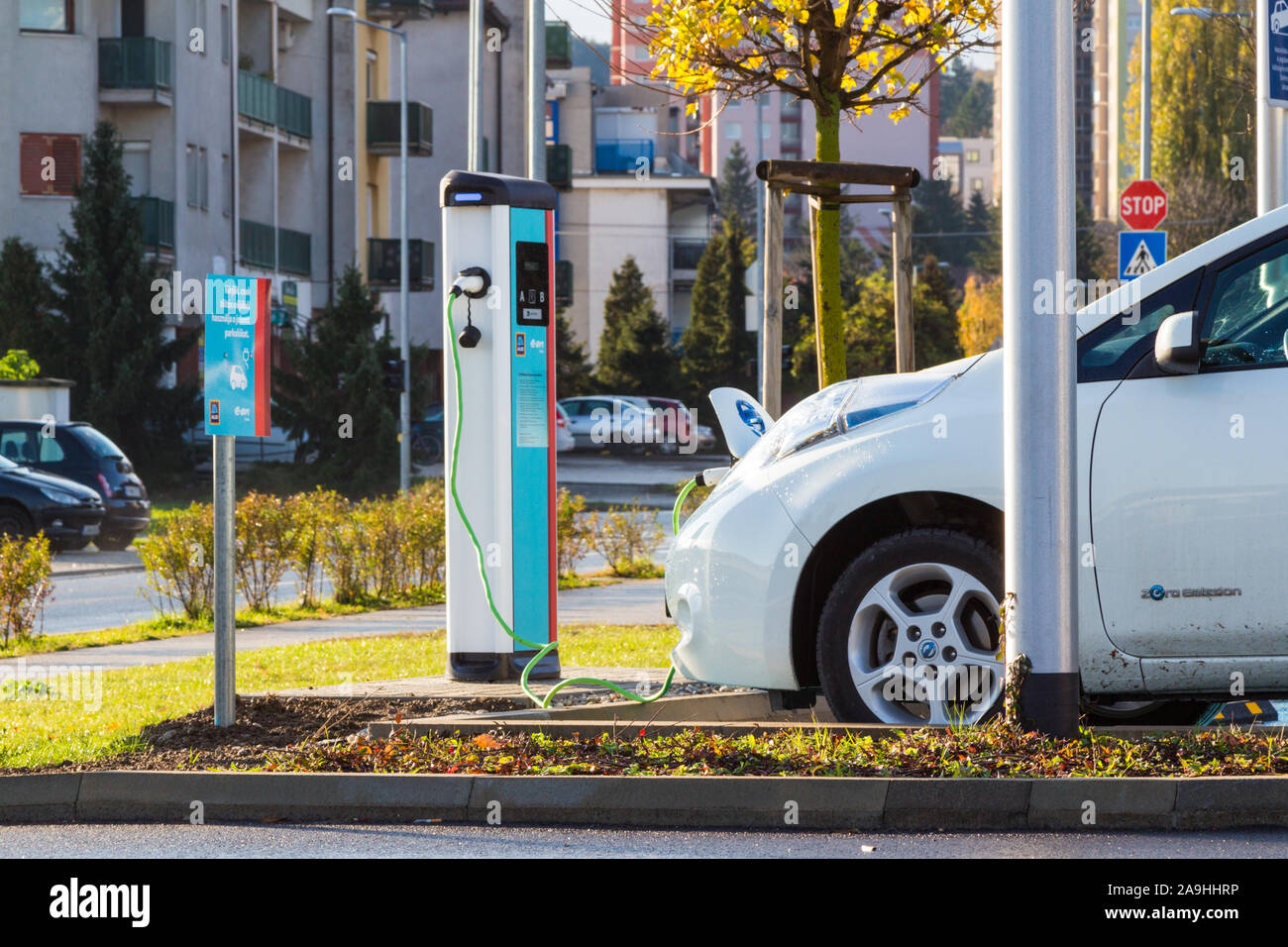Nissan LEAF zero emission electric car being charged at ALDI charging