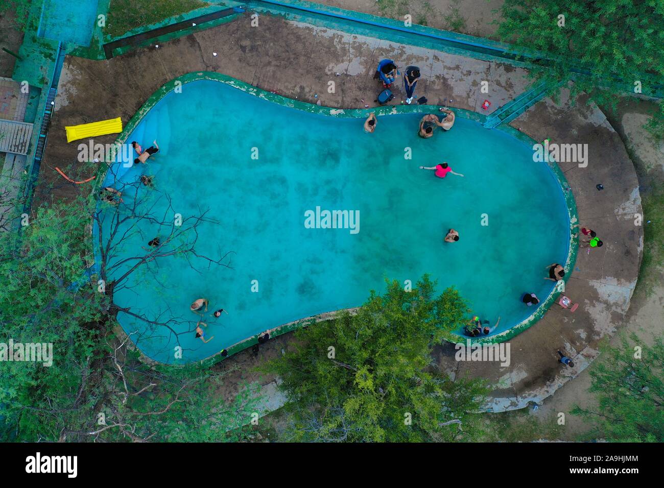 Aerial view of vacationers bathing in the hot spring pool of the