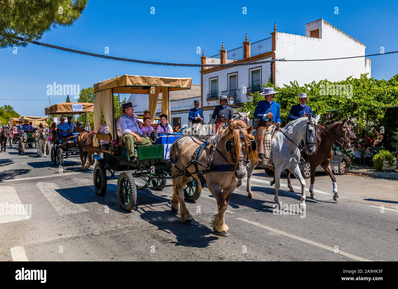 The Romería de El Rocío or  El Rocío pilgrimage passing though the  town of Santiponce Spain Stock Photo