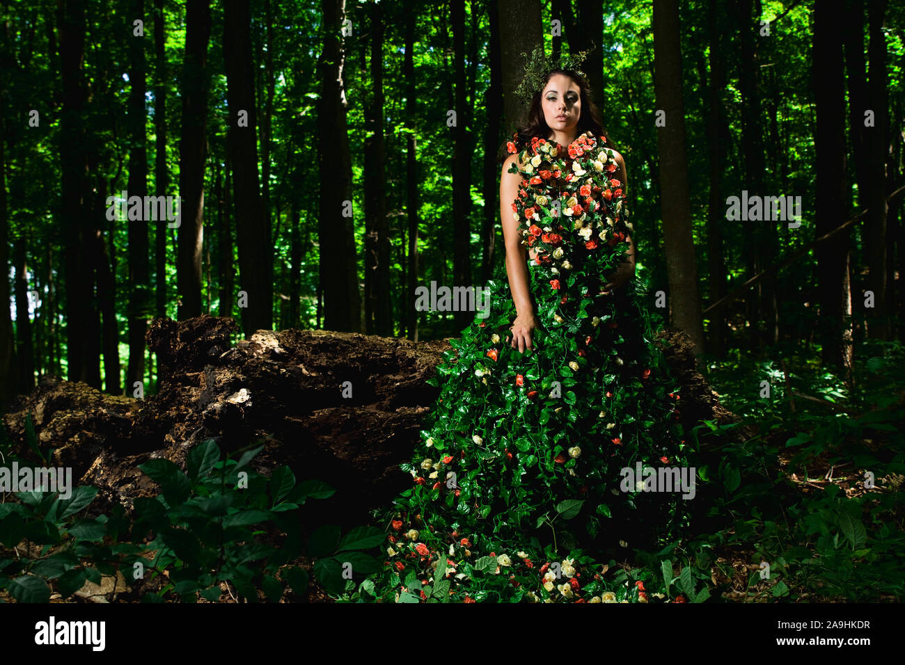 Outdoor high fashion of woman in dress made of leaves and roses Stock Photo