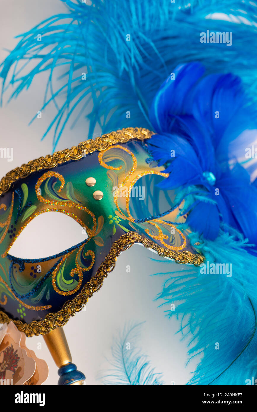 A blue masquerade mask with feathers on a white background Stock Photo