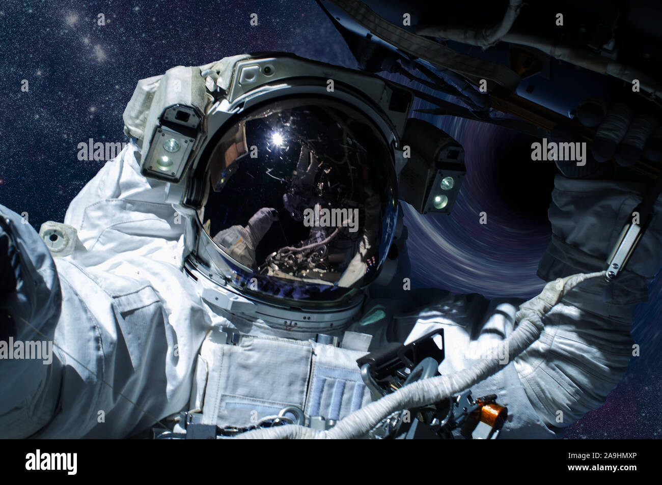 Astronaut with spaceship in a front of black hole in outer space. Global disaster avoid concept, Elements of this image were furnished by NASA Stock Photo