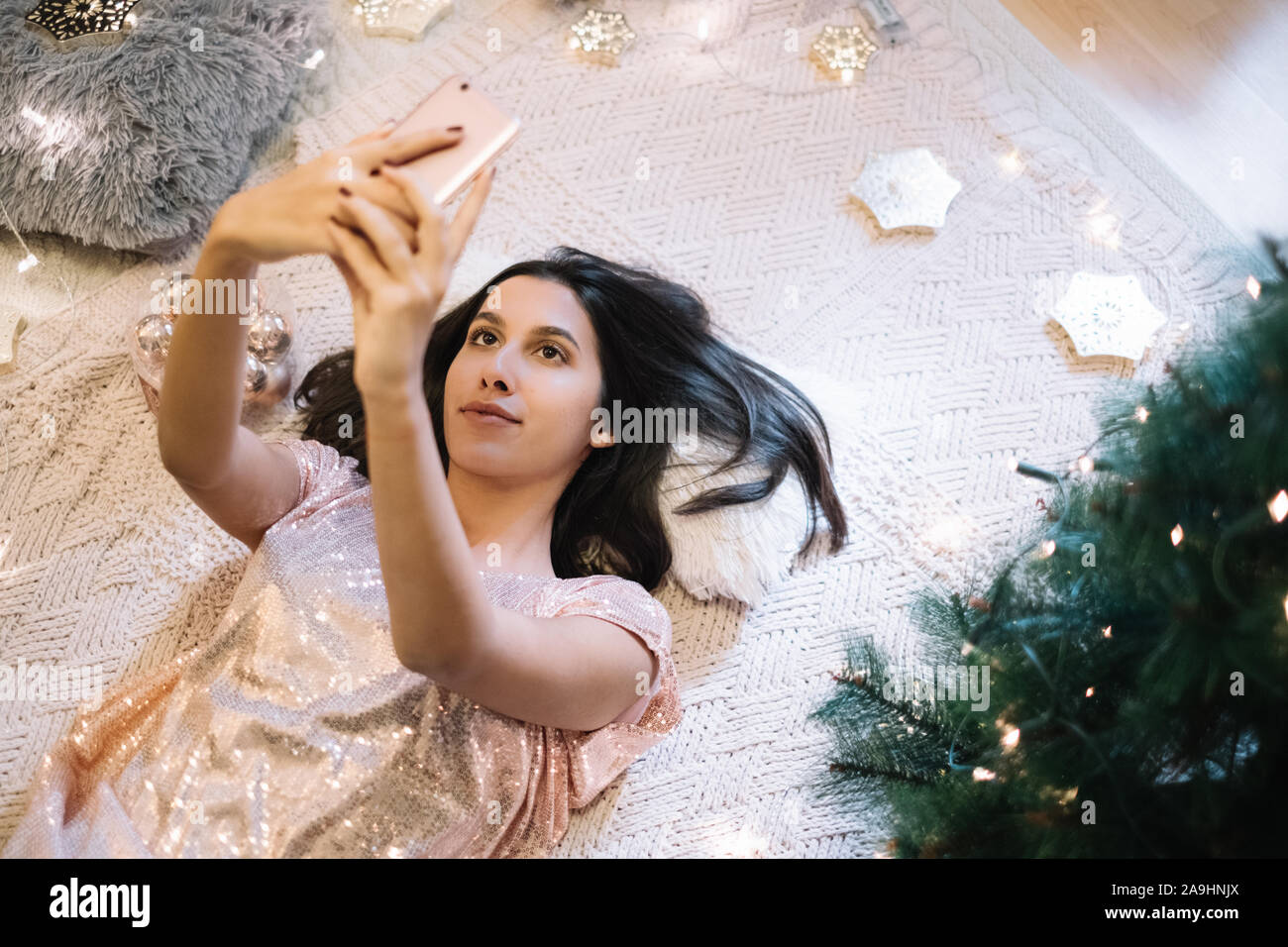 Girl laying on floor and taking selfie Stock Photo - Alamy