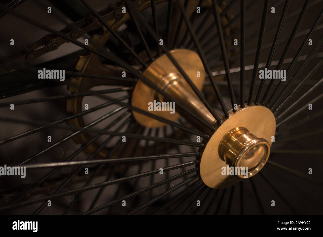Close up view of black steel and brass wheel spoke on an antique carriage. Stock Photo