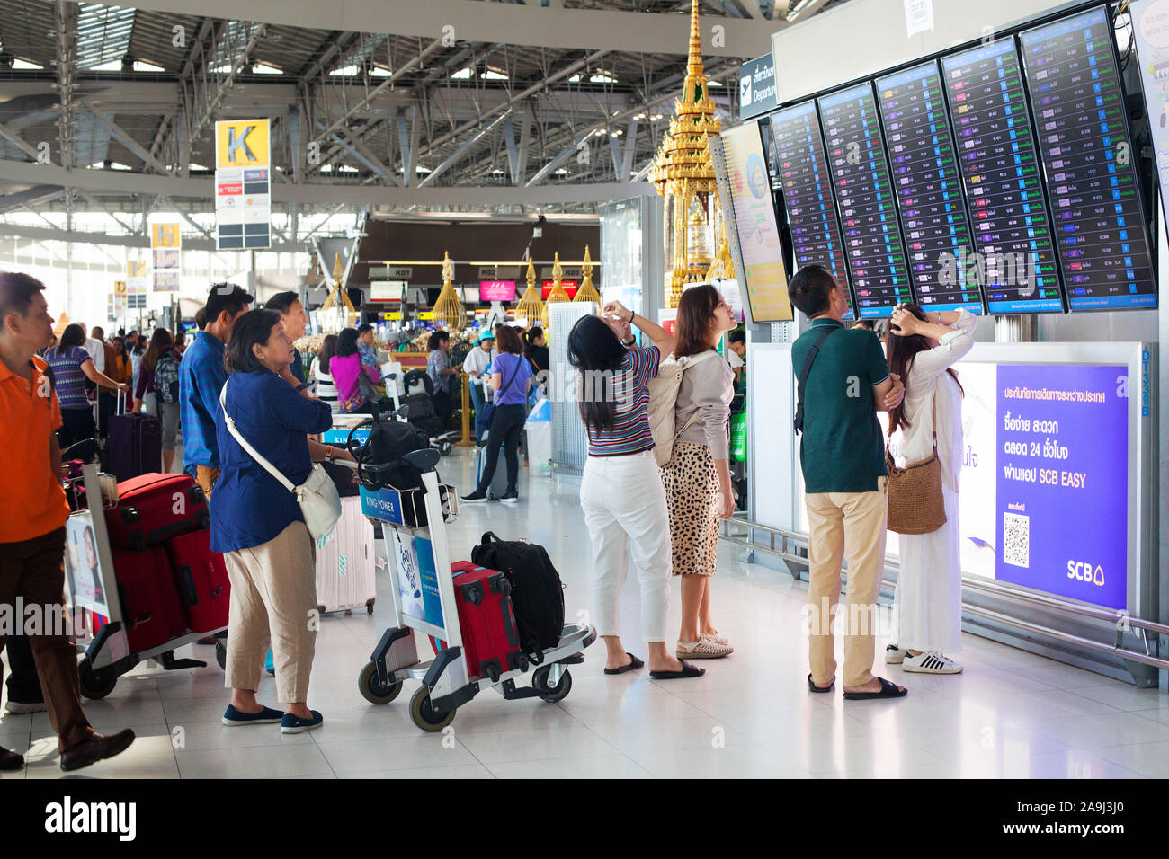 Bangkok, Thailand, International Airport Suvarnabhumi people at flight schedule screen, passengers, display board, airplanes time and gate information Stock Photo