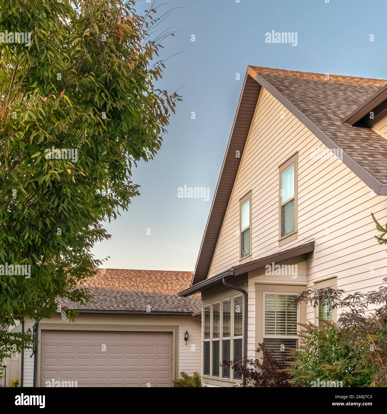 Square frame Concrete driveway leading to a double garage Stock Photo