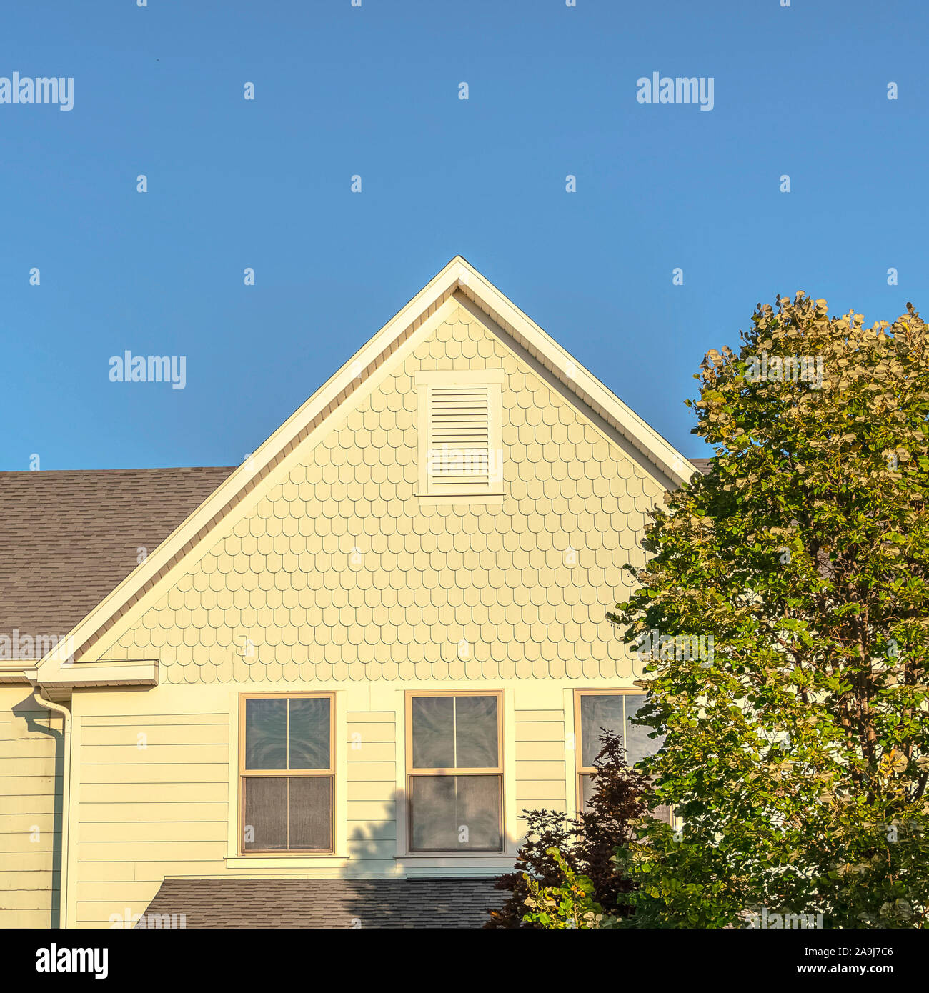 Square Facade of a large yellow house in evening light Stock Photo - Alamy
