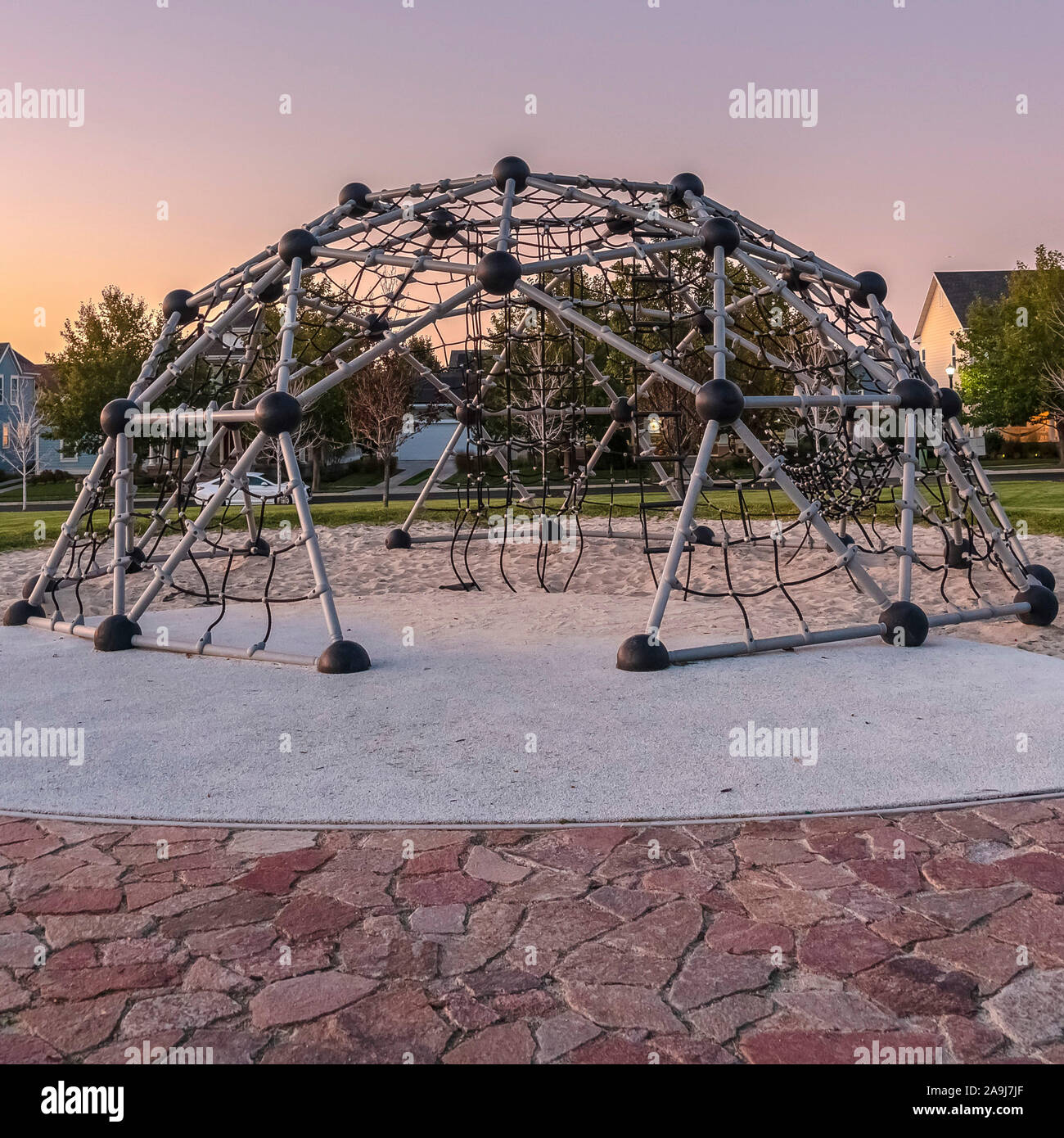 Square Metal climbing frame in a playground at sunset Stock Photo - Alamy