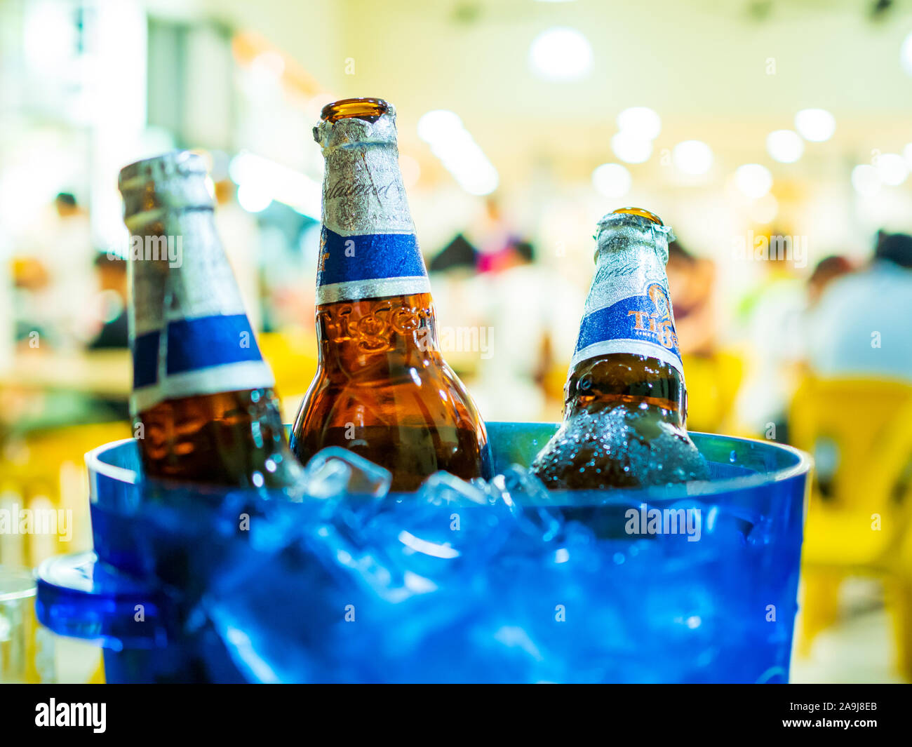 SINGAPORE - 17 MAR 2019 - close up of Tiger beer bottles in a bucket of ice at a coffeeshop in Singapore Stock Photo