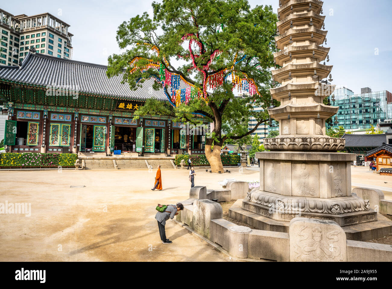 Seoul Korea , 25 September 2019 : Jogyesa temple view with the Daeungjeon hall the pagoda tree and people praying in Seoul South Korea Stock Photo