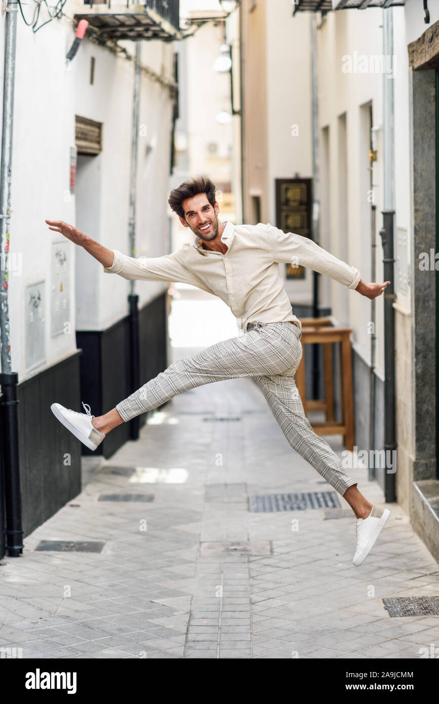 Young funny man jumping in the street. Stock Photo