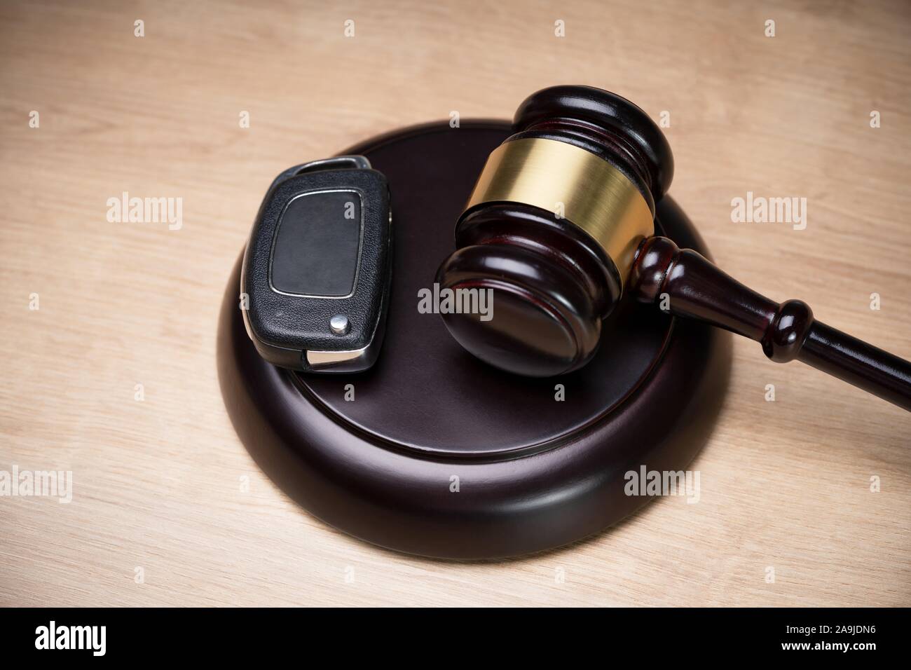 Overhead View Of A Car Key And Mallet On The Striking Block Stock Photo