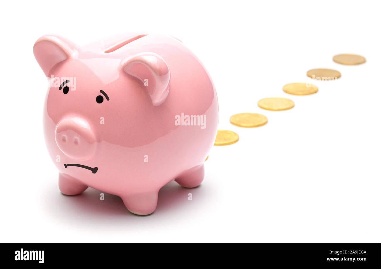 Loss of money. Pink piggy bank losing gold coins isolated on a white  background. Bad investment or falling profits Stock Photo - Alamy