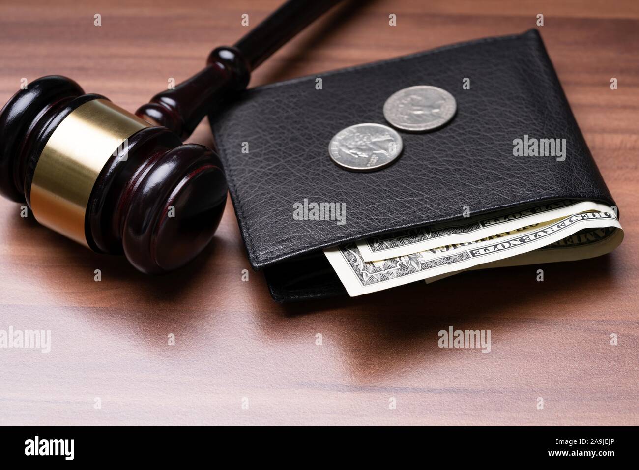 Black Leather Pocket With Banknotes And Coins Near Judge Gavel Over Wooden Desk Stock Photo