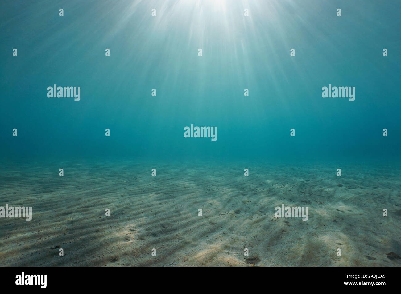 Sand underwater on the seabed with sunlight, natural scene, Mediterranean sea Stock Photo