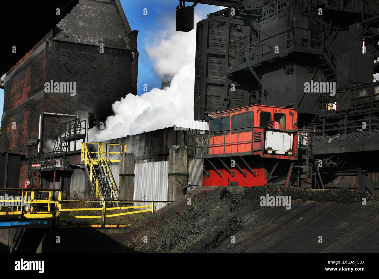Pushing hot coke on a coke oven plant on large integrated steelworks Stock Photo