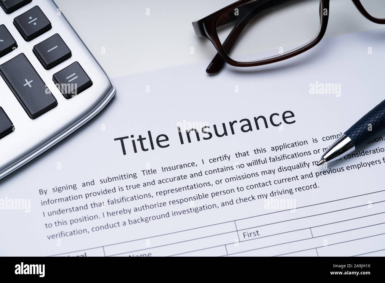 Title Insurance Form Near Calculator And Glasses Stock Photo