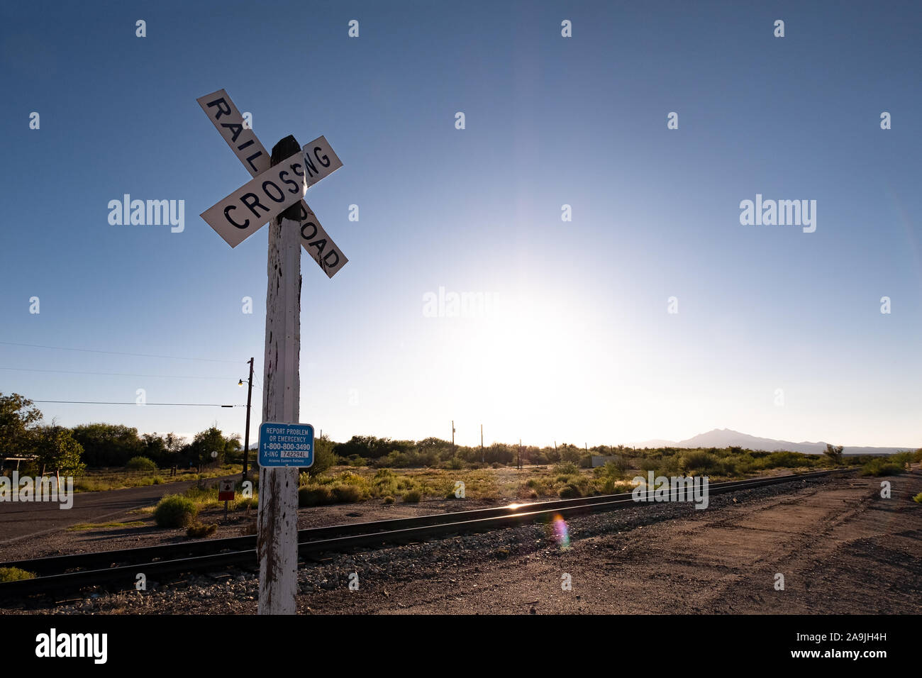 railroad crossing sign and railroad track against clear sky in the United States Stock Photo