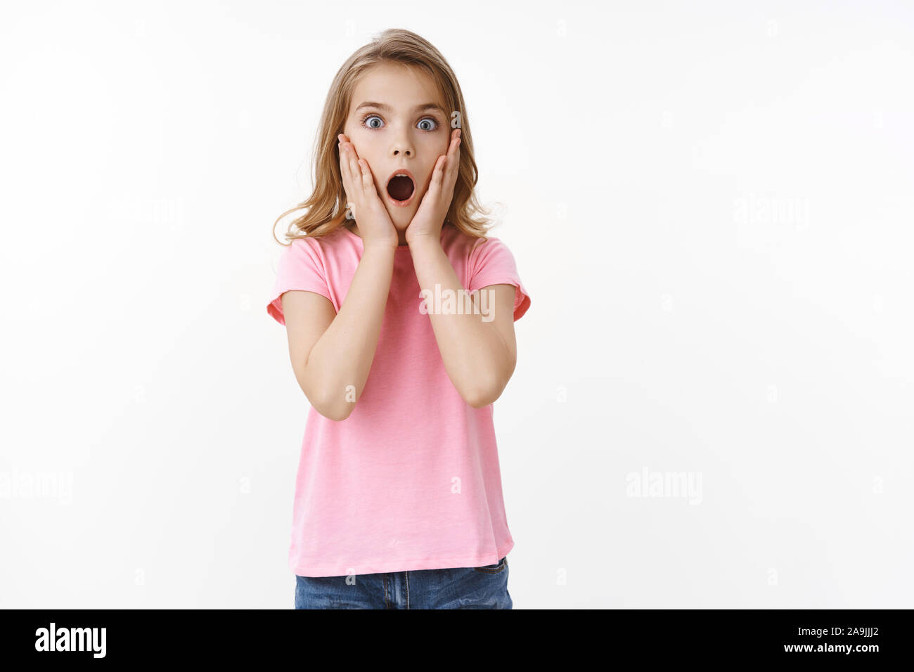 Shocked amazed cute little kid, blond teenage girl, gasping amazed