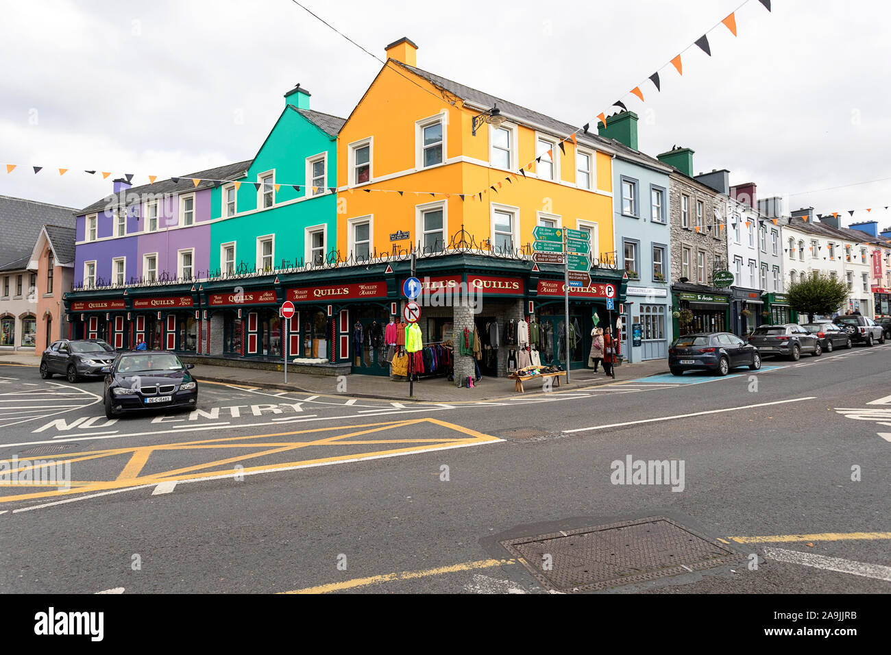 Pubs, shop, hotels and restaurants on a street in Kenmare, decorated