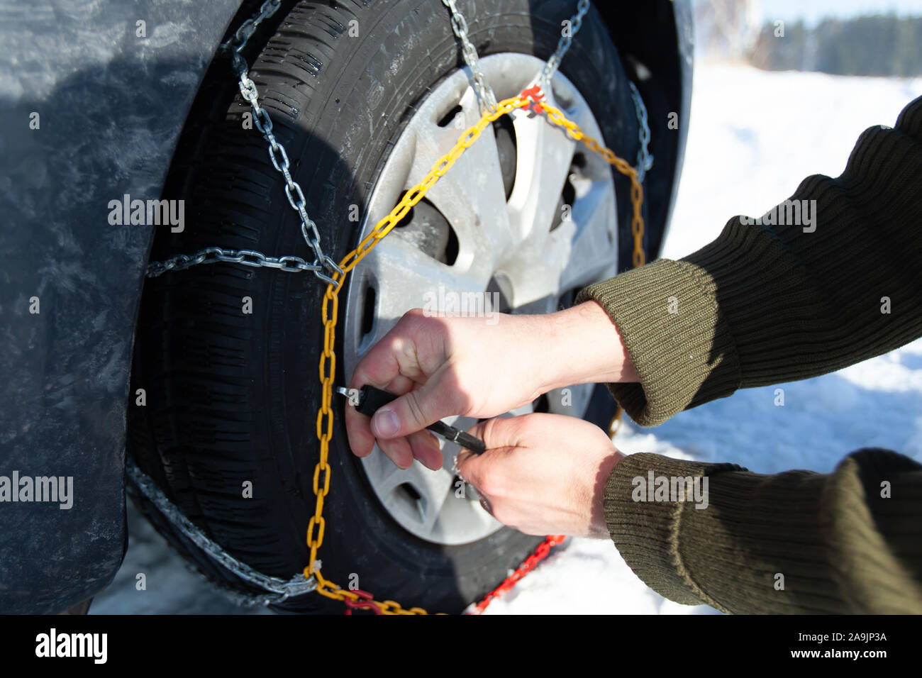 Car stuck in the snow drift. Tire fitted with snow chains Stock Photo Alamy
