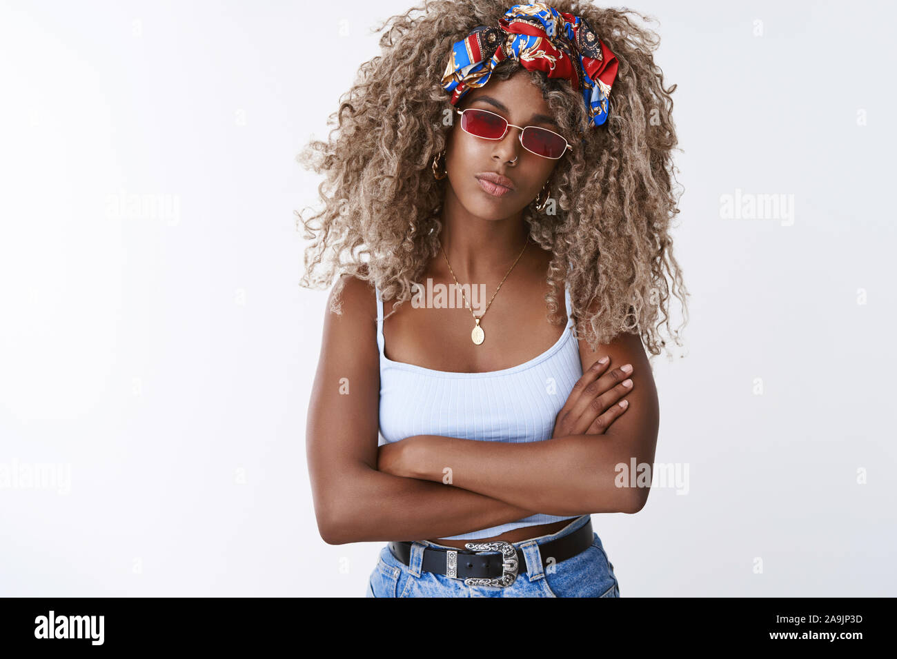 Stylish good-looking african-american blond woman with afro hairstyle, wear cool red glasses, eyewear ready for party, hold hands crossed in confident Stock Photo - Alamy Stylish good-looking african-american blond woman with afro hairstyle, wear cool red glasses, eyewear ready for party, hold hands crossed in confident Stock Photo - Alamy