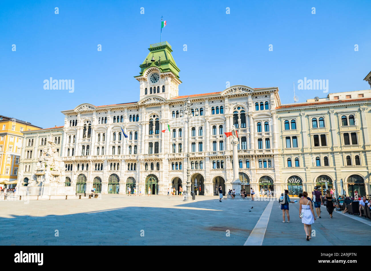 Trieste, Italy - 05.08.2015 : View of Trieste City Hall building in Itally with tourists passing by. Travel destination Stock Photo