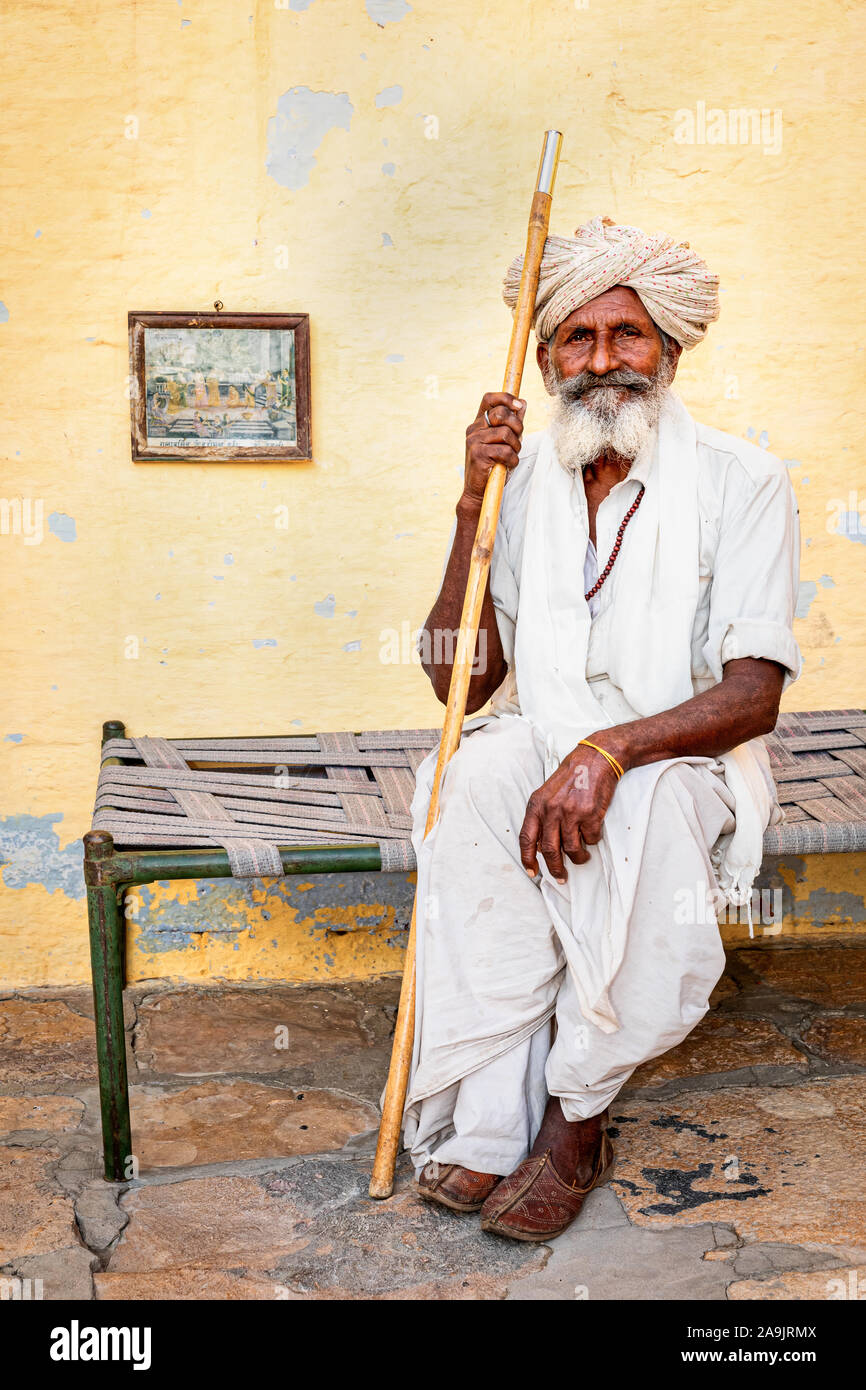 Elderly Indian man resting on a bed, Jaisalmer, Rajasthan, India Stock Photo