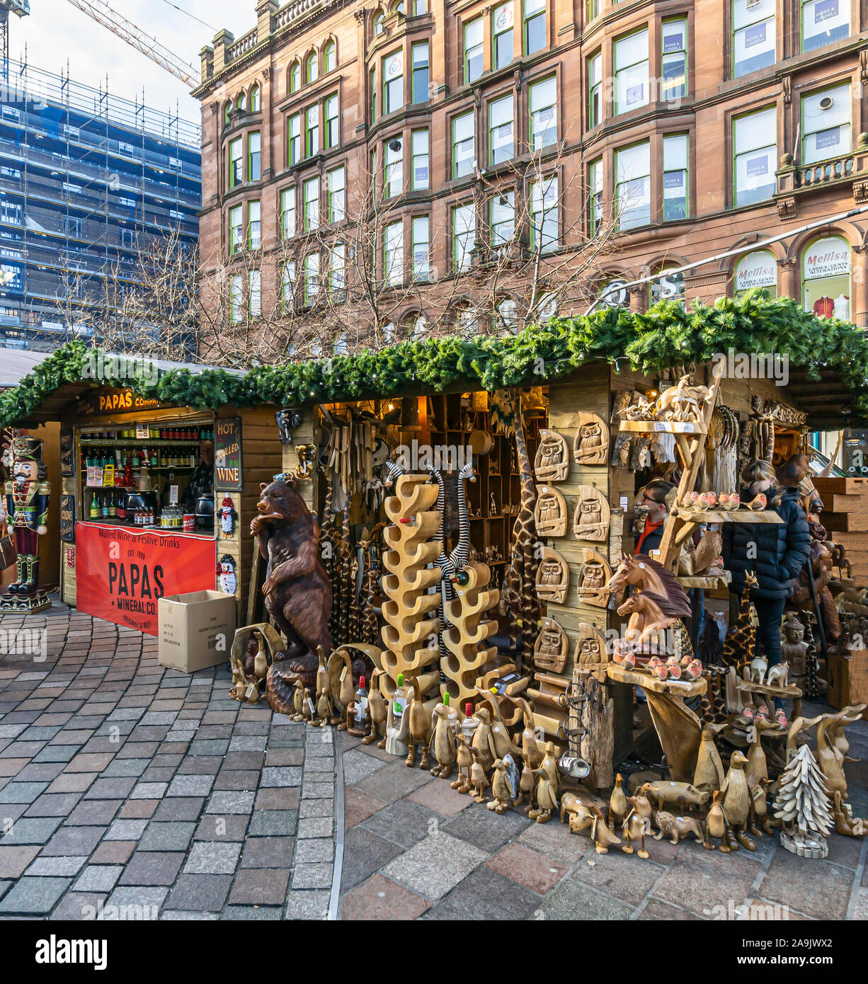 Glasgow Christmas Market 2019 in St Enoch Square Glasgow Scotland with stalls selling wooden ornaments and papas. Stock Photo