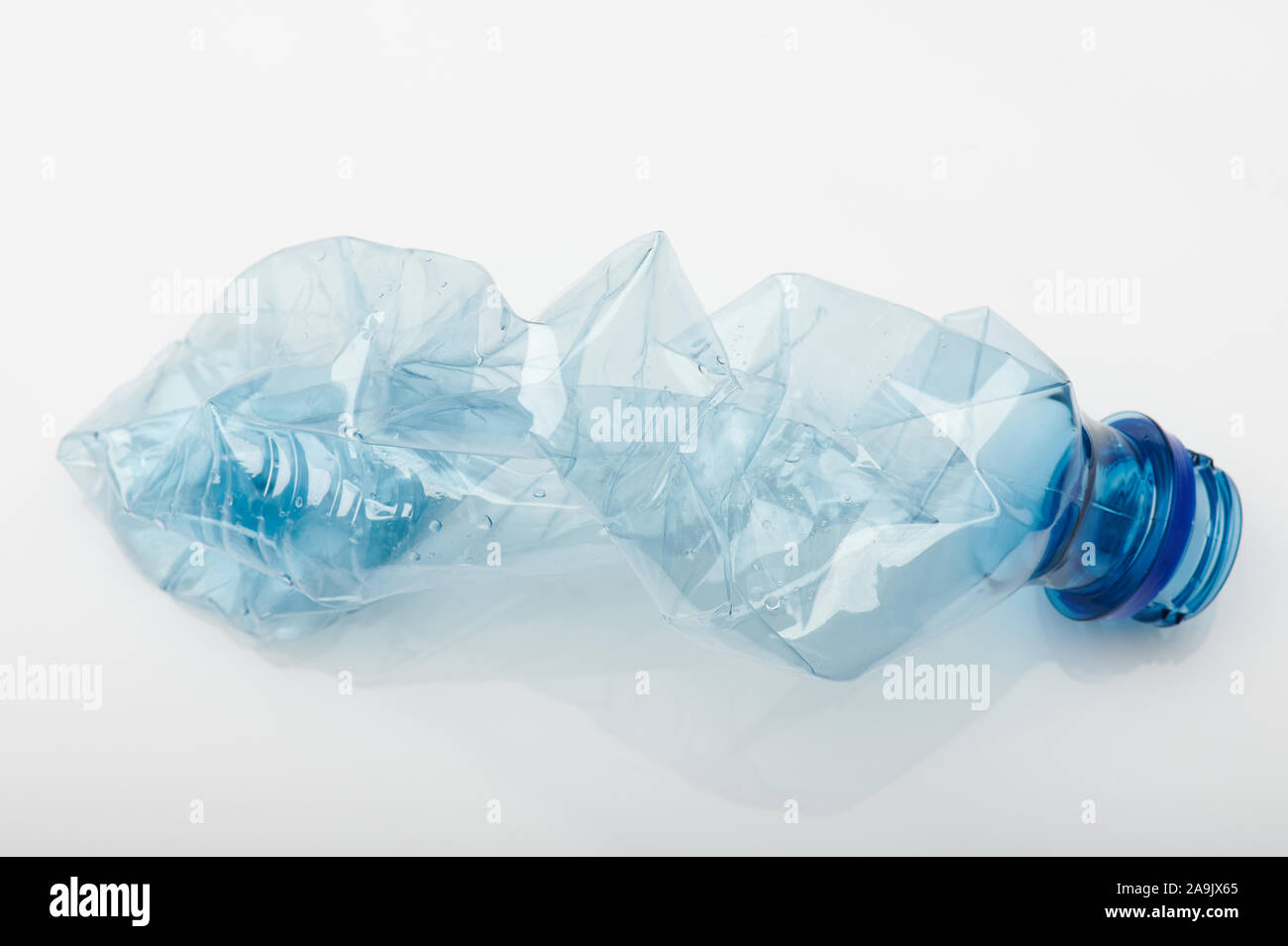 Blue crashed plastic bottle isolated on white background Stock Photo