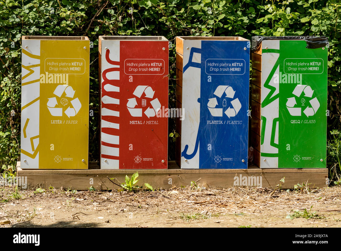 KRONGJI, ALBANIA - JUNE 7, 2019: Paper, plastic, metal and glass waste recycle bins, Blue Eye national natural park outdoors, Albania, sunny spring day Stock Photo