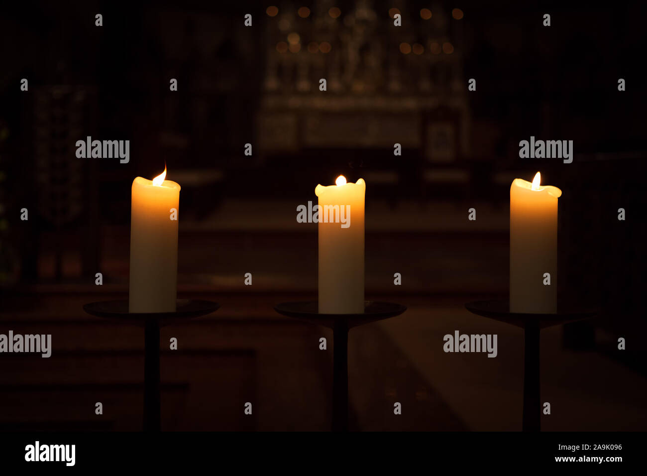 three candles on the black background Stock Photo - Alamy