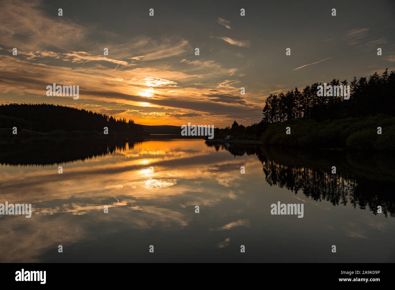 Alwen reservoir with reflections at sunset, North Wales Stock Photo