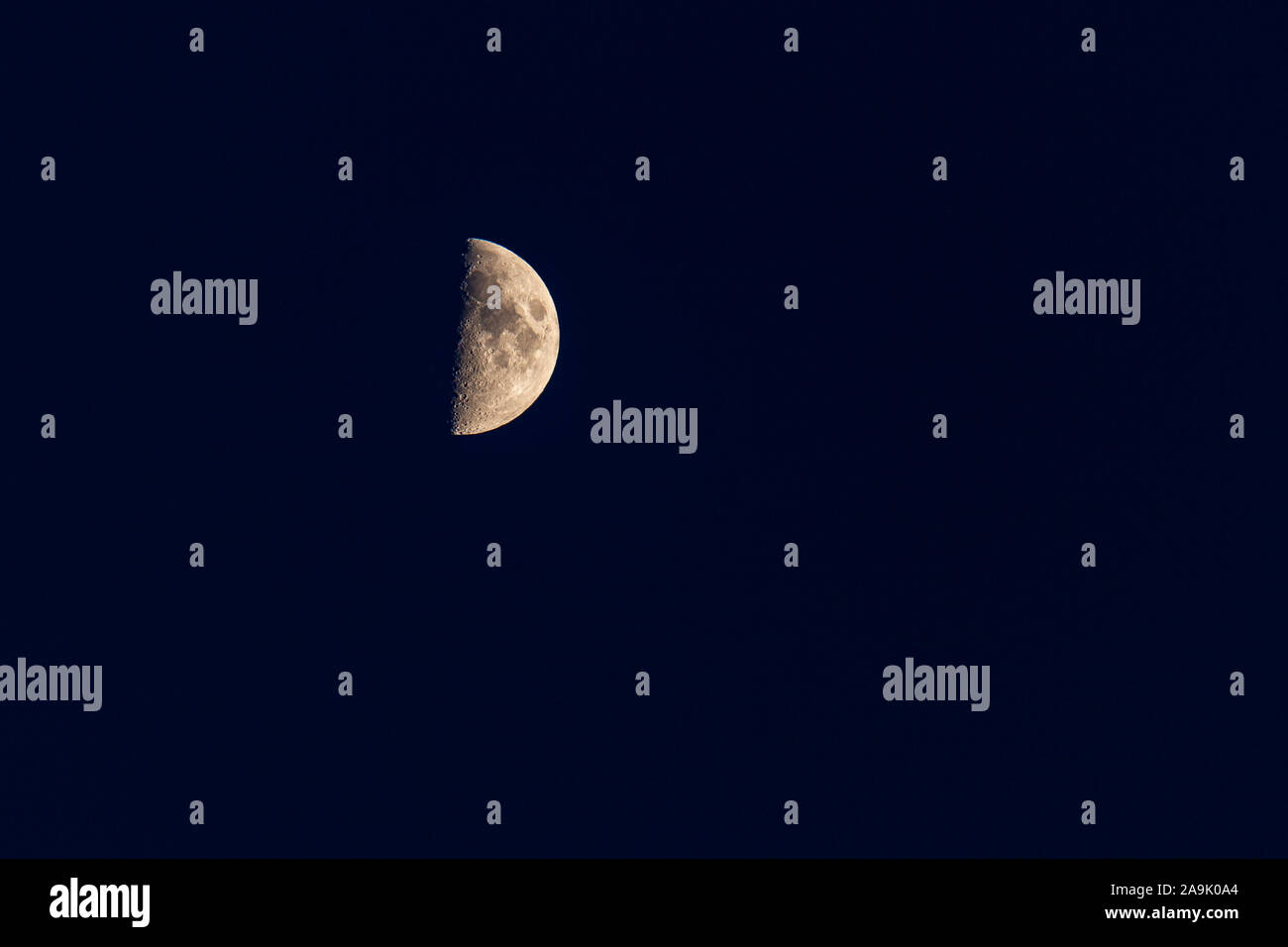 Moon at half phase at night with craters Stock Photo