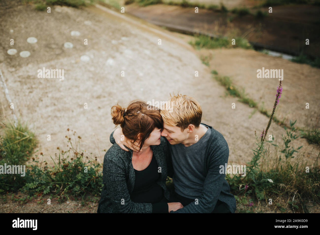 boyfriend puts his arm around his girlfriend Stock Photo Alamy