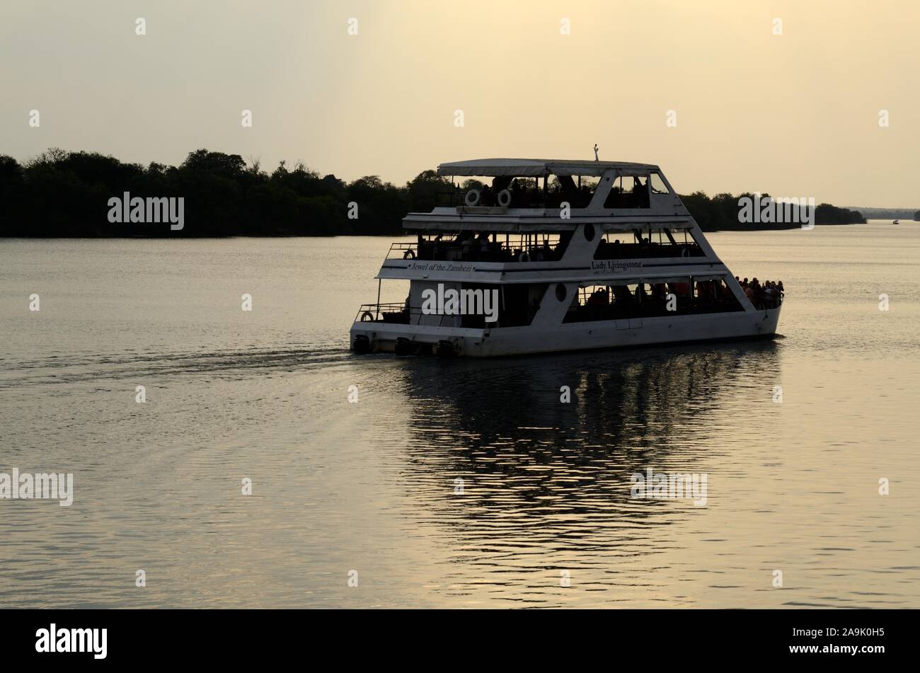 Tourist sight seeing pleasure cruse on the Zambezi River at sunset Zambia Africa Stock Photo