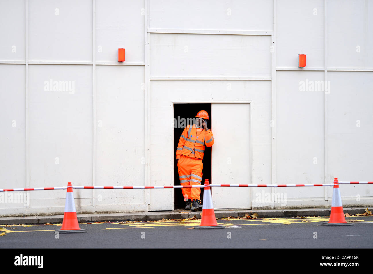 London, England, UK. Worker in hi vis overalls on his mobile phone, Whitehall Stock Photo