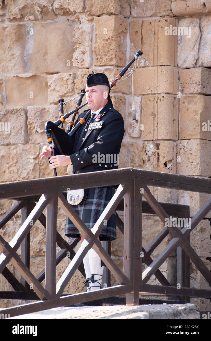 Lone Scotts piper remembrance day service paphos cyprus number 3926 Stock Photo