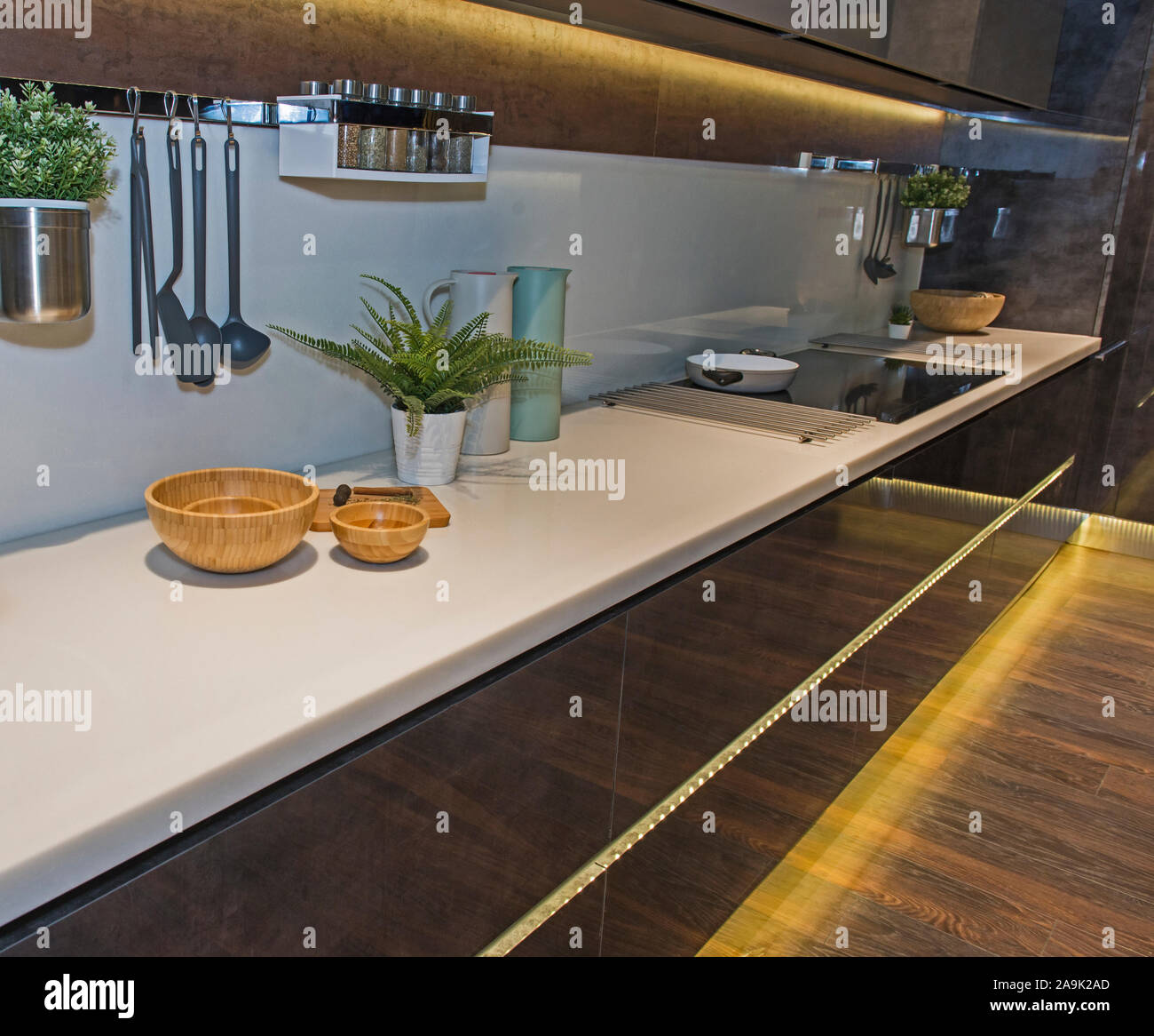 Interior design decor showing modern kitchen and induction hob in luxury apartment showroom Stock Photo