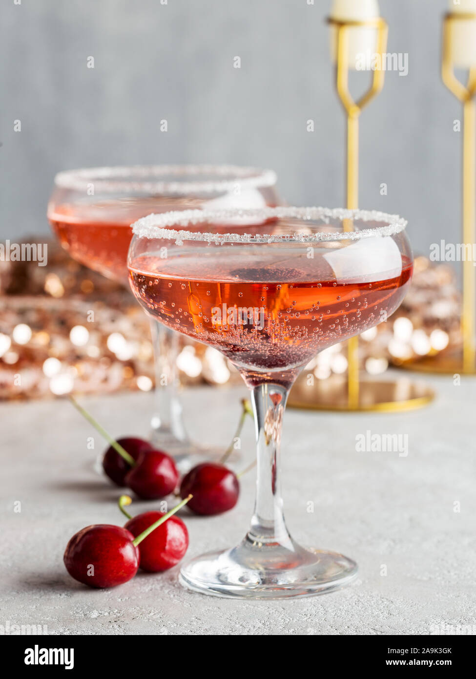 Cherry champagne in glasses with berries on Christmas or New Year's party Stock Photo