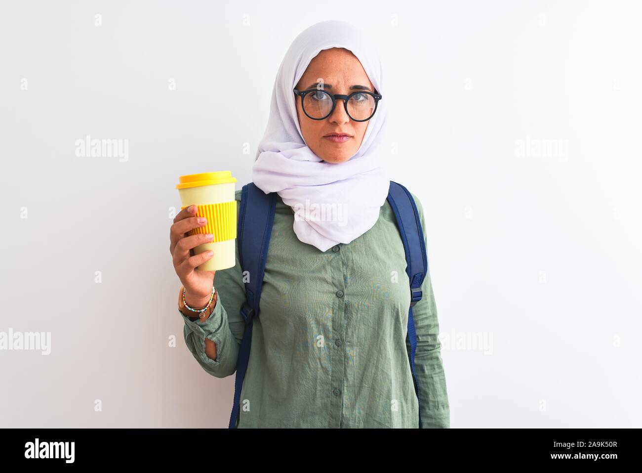 Young Arab student woman wearing hijab and drinking coffee over ...