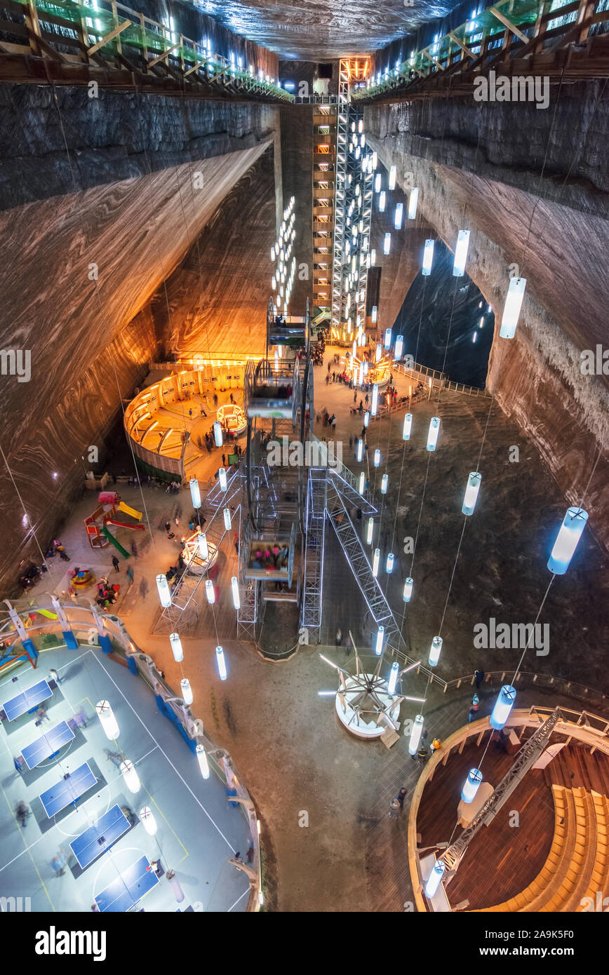 TURDA, ROMANIA - APR 30, 2018: Hall of Salt Mine Salina Turda museum. popular travel destination. underground place with ferris wheel, tennis courts a Stock Photo
