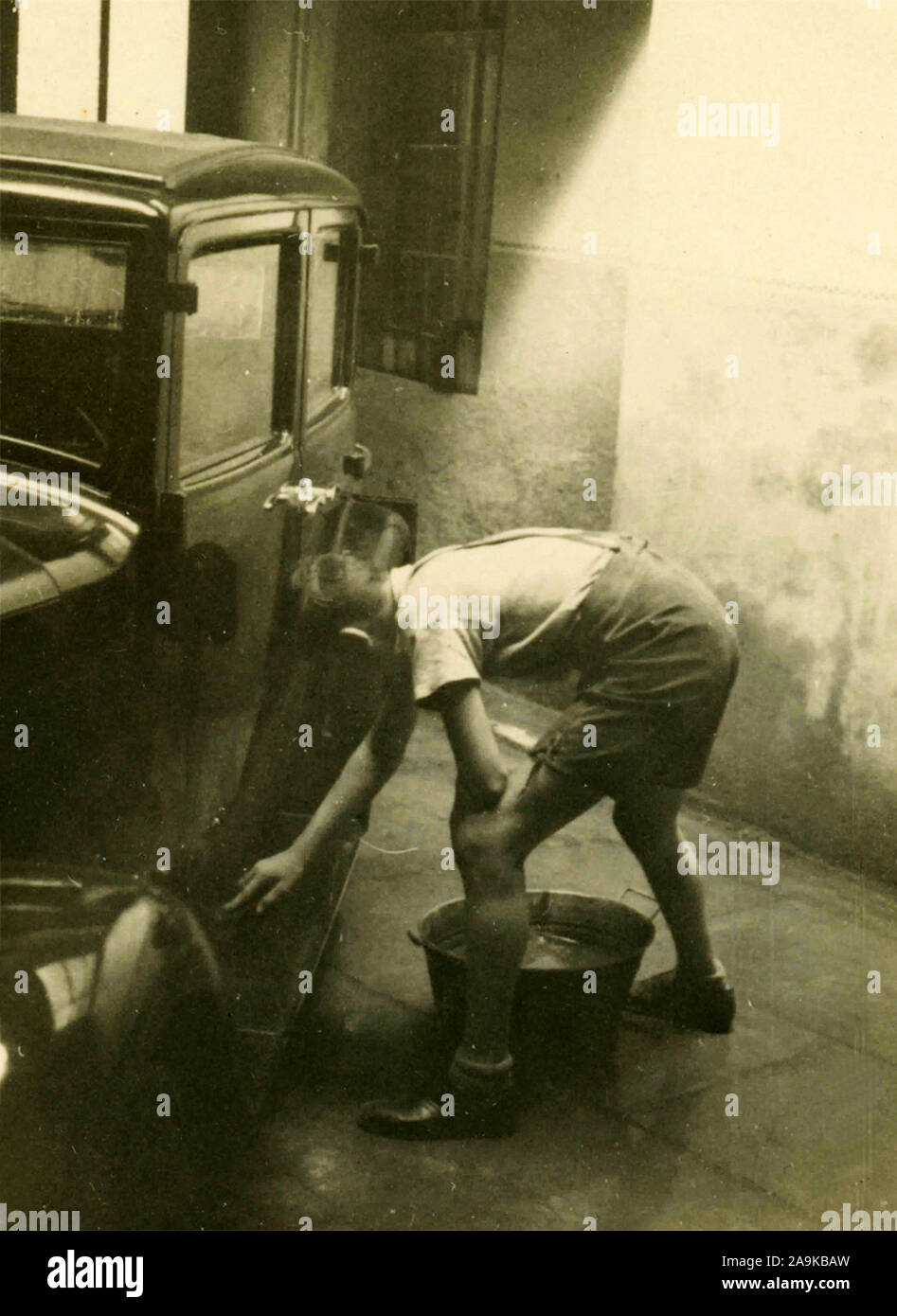 Boy washes a car, Italy Stock Photo