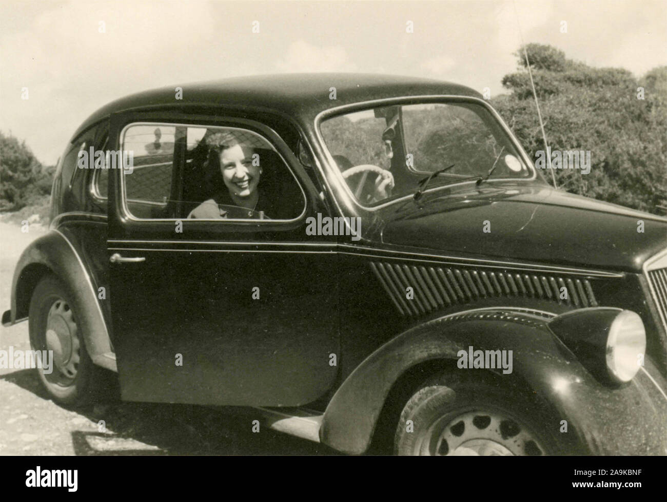 Woman driving a FIAT Topolino car, Italy Stock Photo