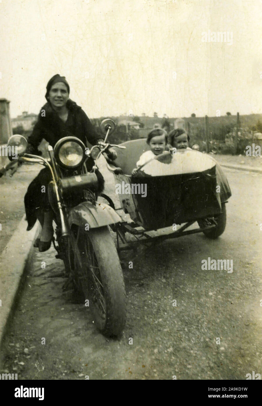 Women with children on motorbike with sidecar, Italy Stock Photo